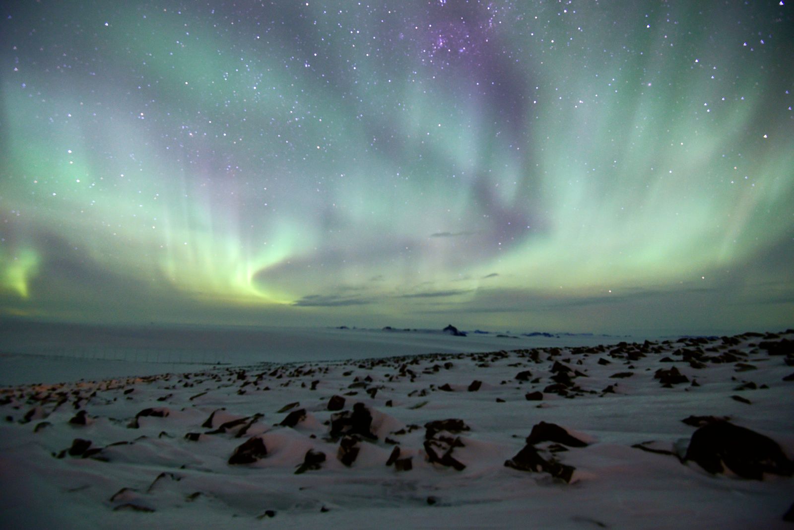 The Aurora Australis over the Antarctic ice sheet at night